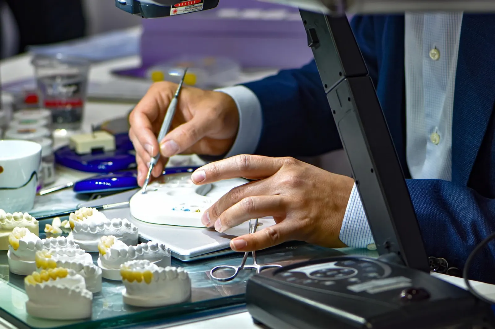 A dental lab technician fabricating an orthotic appliance